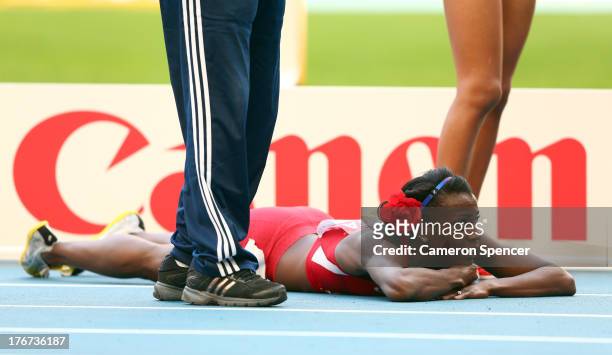Alysia Johnson Montano of the United States lies on the track after falling at the finish line in the Women's 800 metres final during Day Nine of the...