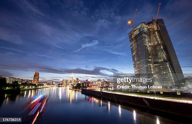 The new construction for the European Central Bank stands on the eastside of Frankfurt with the skycrapers of the skyline illuminated in the...