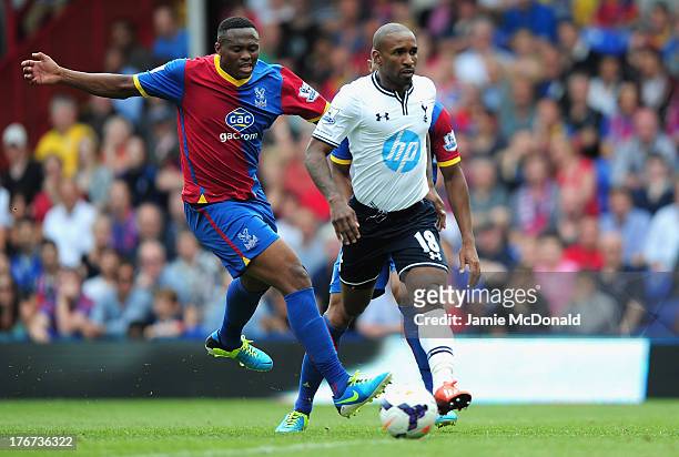 Jermain Defoe of Tottenham Hotspur is closed down by Kagisho Dikgacoi of Crystal Palace during the Barclays Premier League match between Crystal...