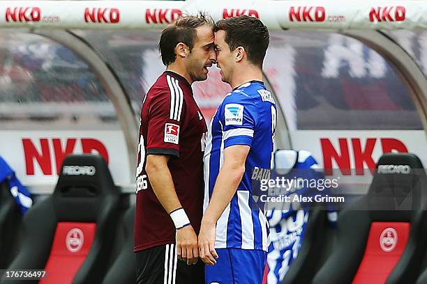 Javier Pinola of Nuernberg and Alexander Baumjohann of Berlin discuss during the Bundesliga match between 1. FC Nuernberg and Hertha BSC Berlin at...