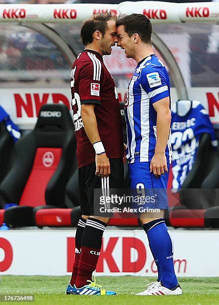 Javier Pinola of Nuernberg and Alexander Baumjohann of Berlin discuss during the Bundesliga match between 1. FC Nuernberg and Hertha BSC Berlin at...