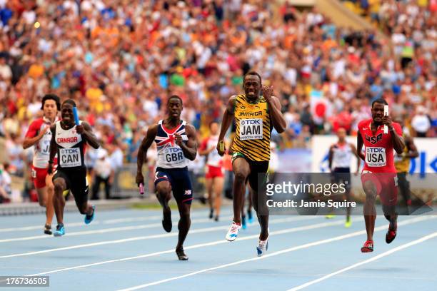 Usain Bolt of Jamaica crosses the line first to win gold ahead of second place Justin Gatlin of the United States and third place Justyn Warner of...