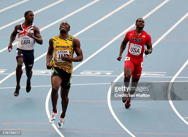 Usain Bolt of Jamaica crosses the line first to win gold ahead of second place Justin Gatlin of the United States and third place Dwain Chambers of...