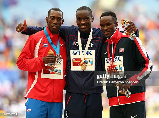 Silver medalist Pedro Pablo Pichardo of Cuba, gold medalist Teddy Tamgho of France and bronze medalist Will Claye of the United States stand on the...