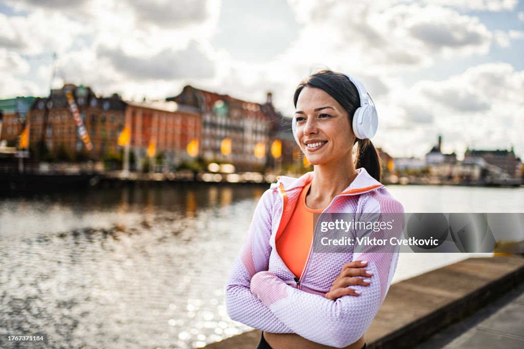 Portrait of a young female runner by the river in the city of Malmo, Sweden