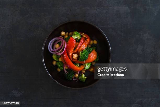 vegan salad with roasted red bell peppers, chickpeas, hazelnuts, broccoli, healthy plant based meal - plate of food stock pictures, royalty-free photos & images