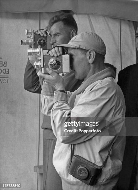 Soviet rowing coaches E. Kabanov and Boris Brechko, filming an event at Henley Royal Regatta, Oxfordshire, 3rd July 1958.