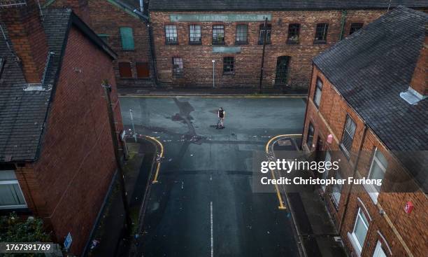 An aerial view of a boy playing in the street near the Heron Cross pottery kiln on October 31, 2023 in Stoke on Trent, England Government figures...