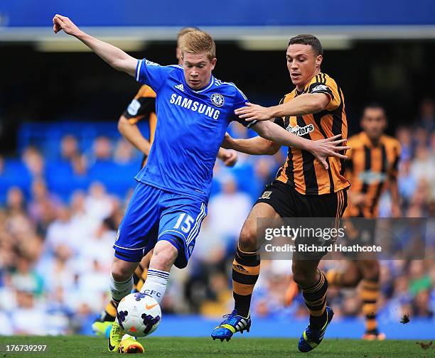 Kevin De Bruyne of Chelsea is challenged by James Chester of Hull City during the Barclays Premier League match between Chelsea and Hull City at...