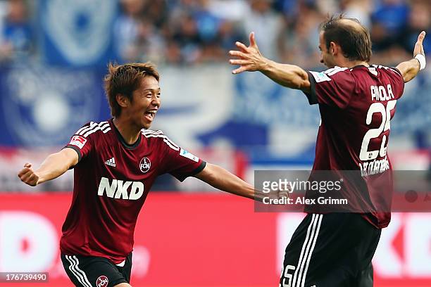 Hiroshi Kiyotake of Nuernberg celebrates his team's second goal with team mate Javier Pinola during the Bundesliga match between 1. FC Nuernberg and...