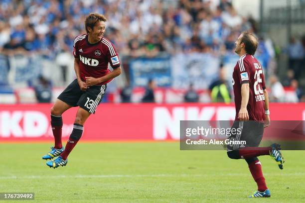 Hiroshi Kiyotake of Nuernberg celebrates his team's second goal with team mate Javier Pinola during the Bundesliga match between 1. FC Nuernberg and...