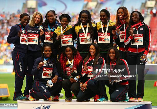 Silver medalists team France, gold medalists team Jamaica and bronze medalists pose on the podium during the medal ceremony for the Women's 4x100...