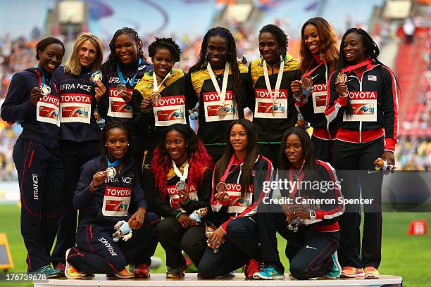 Silver medalists team France, gold medalists team Jamaica and bronze medalists pose on the podium during the medal ceremony for the Women's 4x100...