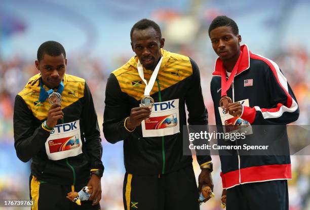 Silver medalist Warren Weir of Jamaica, gold medalist Usain Bolt of Jamaica and bronze medalist Curtis Mitchell of the United States stand on the...