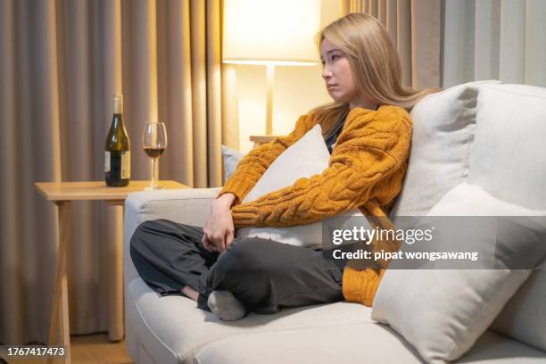 woman sits lonely and depressed in the house. - drunk asian women stock pictures, royalty-free photos & images