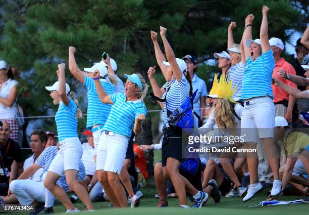 Suzann Pettersen of Norway, Caroline Hedwall of Sweden and the European Team celebrate as Karine Icher clinched the final match on the 18th green...