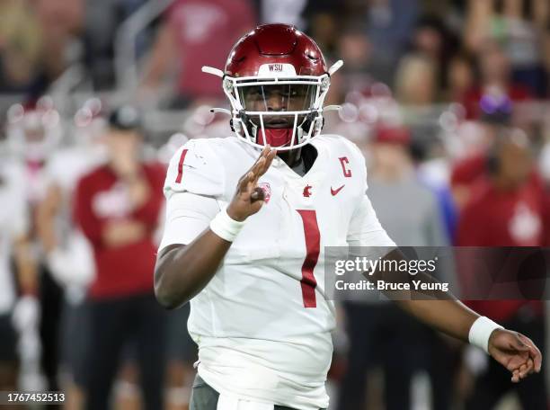 Cameron Ward of the Washington State Cougars looks to receivers to confirm the play called in the first quarter against the Arizona State Sun Devils...