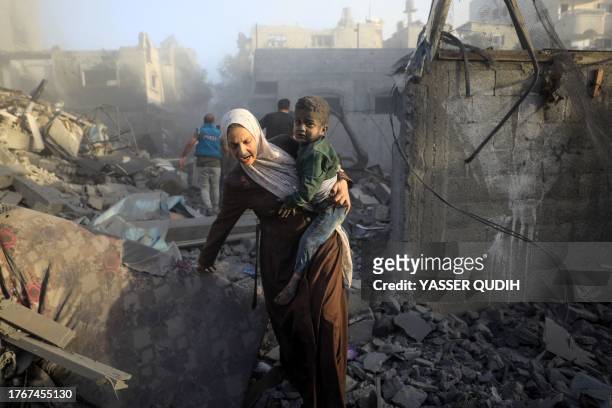 People flee following Israeli air strikes on a neighbourhood in the al-Maghazi refugee camp in the central Gaza Strip on November 6 amid ongoing...