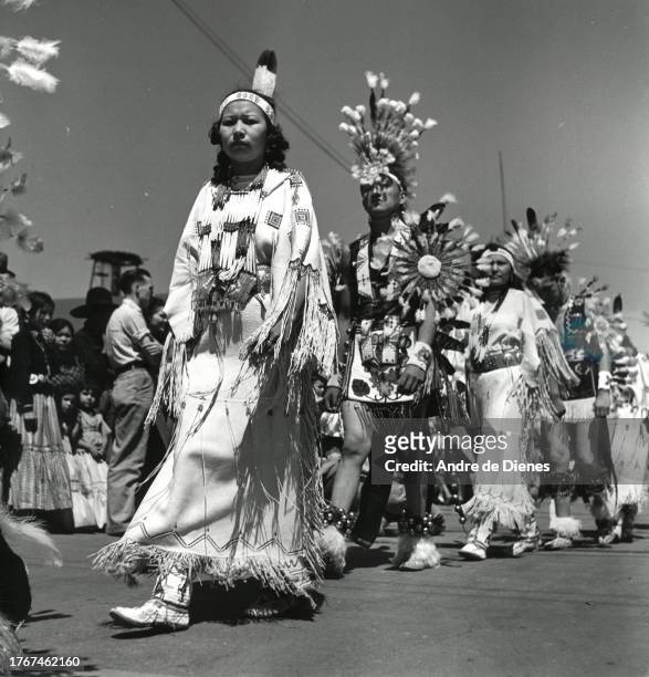 Low-angle view of women and men, in ceremonial Navajo attire, as they participate in the Gallup Inter-Tribal Indian Ceremonial parade, Gallup, New...