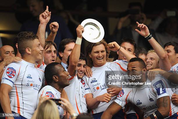 Nate Augspurger of New York holds aloft the trophy as New York celebrate their victory during the Plate Final match between Gloucester and New York...