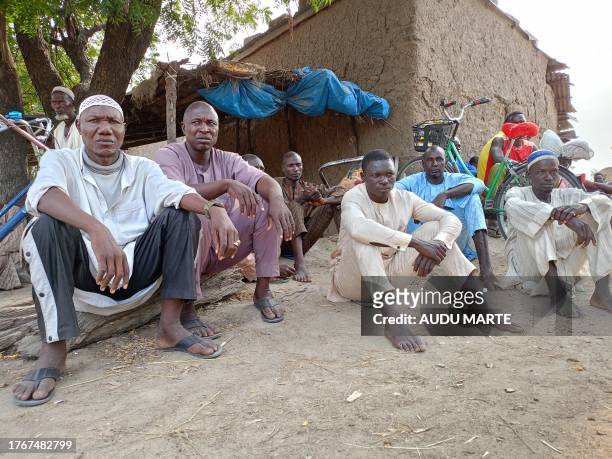 People attend the burial of farmers that were victims of an attack, in the Zabarmari district, near Maiduguri, on November 6, 2023. Jihadists have...