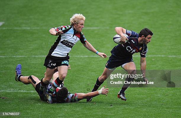 Gonzalo Gutuerrez Taboda of Buenos Aires gets away from Jack Clifford and Freddie Strange of Harlequins during the 3rd / 4th place match between...