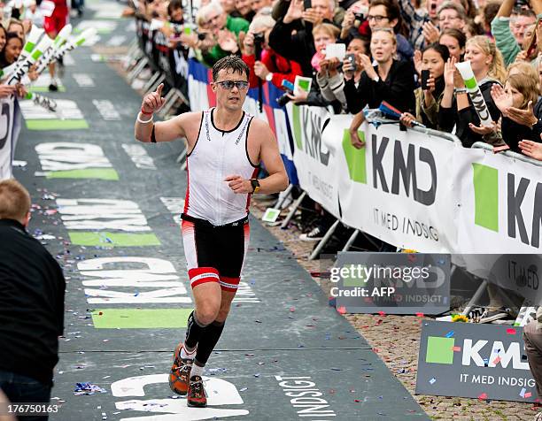 Crown Prince Frederik of Denmark crosses the finish line at the KMD Ironman Copenhagen on August 18, 2013 in Copenhagen, Denmark. The Triathlon...