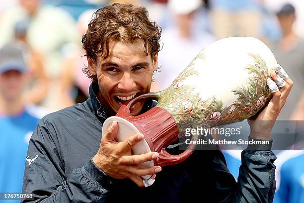 Rafael Nadal poses for photographers with the winners trophy after defeating John Isner during the final of the Western & Southern Open on August 18,...