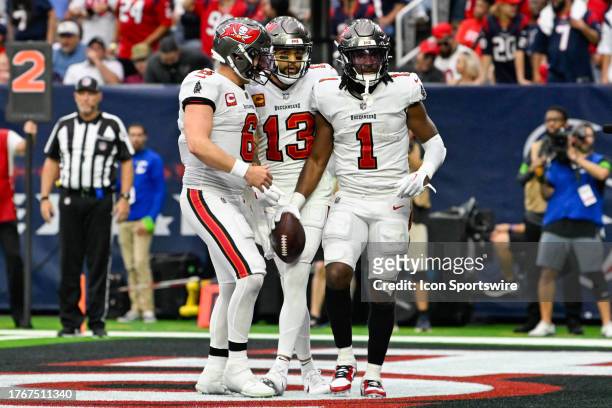 Tampa Bay Buccaneers running back Rachaad White celebrates a touchdown with Tampa Bay Buccaneers quarterback Baker Mayfield and Tampa Bay Buccaneers...