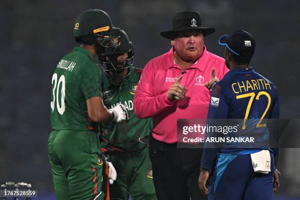 Sri Lanka's Charith Asalanka listens to the umpire as Bangladesh's players watch during the 2023 ICC Men's Cricket World Cup one-day international...