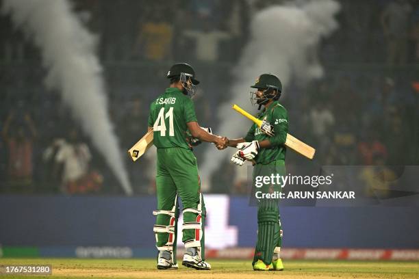 Bangladesh's Tanzim Hasan Sakib and Towhid Hridoy celebrate their win at the end of the 2023 ICC Men's Cricket World Cup one-day international match...