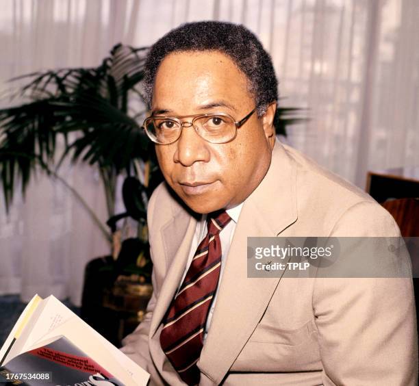 American writer and author Alex Haley poses for a portrait with his book Roots in London, England, April 13, 1977.