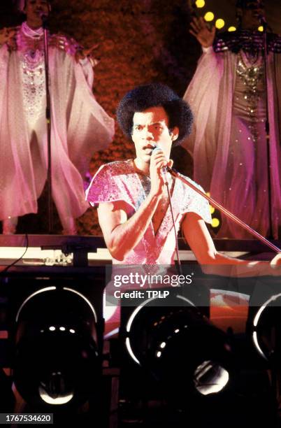 Aruban singer Bobby Farrell , is backed by Marcia Barrett and Maizie Williams, of the German vocal group Boney M., during a concert in London,...