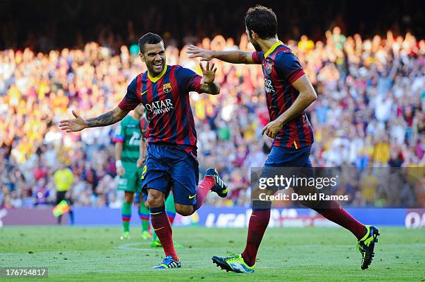 Dani Alves of FC Barcelona celebrates with his team-mate Cesc Fabregas after scoring his team's third goal during the La Liga match between FC...