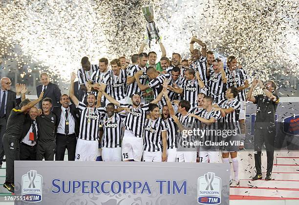 Gianluigi Buffon of Juventus FC and team mates celebrate with the Supercup trophy after the TIM Supercup match between SS Lazio and FC Juventus at...