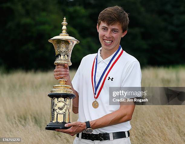 Matt Fitzpatrick of England stands with his trophy after winning the 2013 U.S. Amateur Championship at The Country Club on August 18, 2013 in...