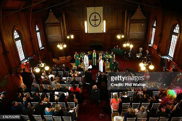 Natasha Vitali and Melissa Ray exchange vows with marriage celebrant Rev Matt Tittle at the Auckland Unitary Church on August 19, 2013 in Auckland,...