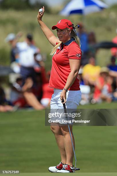 Brittany Lincicome of the United States Team acknowledges the crowd after a birdie putt to win the first hole over Jodi Ewart-Shadoff of England and...