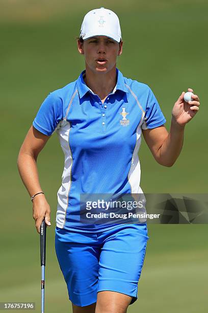 Karine Icher of France and the European Team acknowledges the crowd after halving the first hole with Cristie Kerr of the United States Team during...