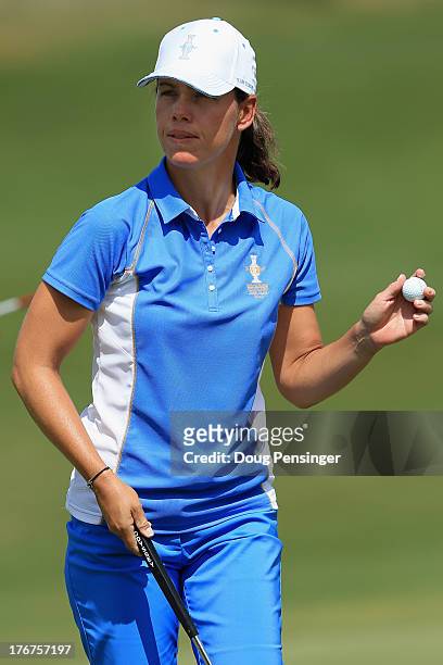 Karine Icher of France and the European Team acknowledges the crowd after halving the first hole with Cristie Kerr of the United States Team during...
