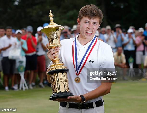 Matt Fitzpatrick of England stands with the Havemeyer trophy after winning the 2013 U.S. Amateur Championship at The Country Club on August 18, 2013...
