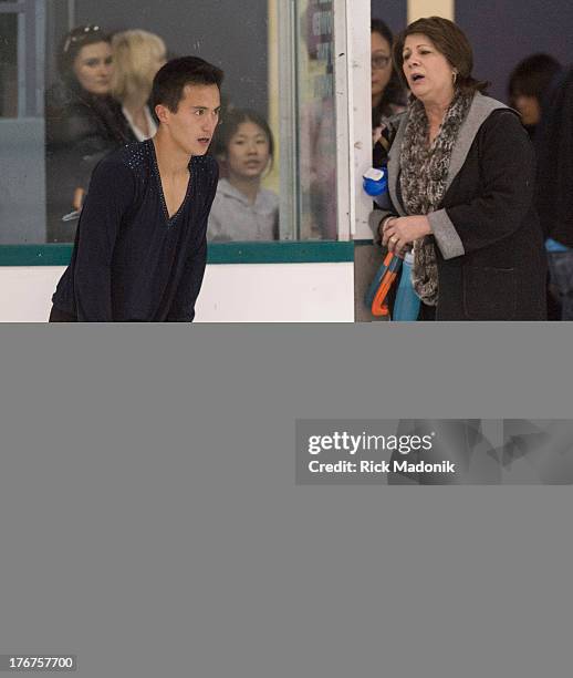 Patrick Chan doesn't appear all that happy with his routine after the finish, while talking with coach Kathy Johnston, at Skate Canada Summer Skate...