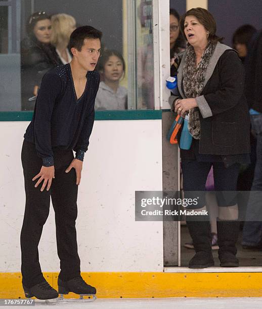 Patrick Chan doesn't appear all that happy with his routine after the finish, while talking with coach Kathy Johnston, at Skate Canada Summer Skate...