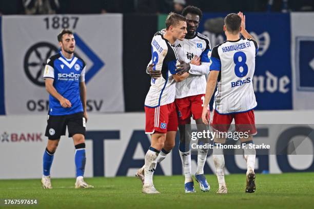 Miro Muheim, Bakery Jatta and Laszlo Benes of Hamburg celebrate while Christopher Lannert of Bielefeld looks dejected during the DFB cup second round...