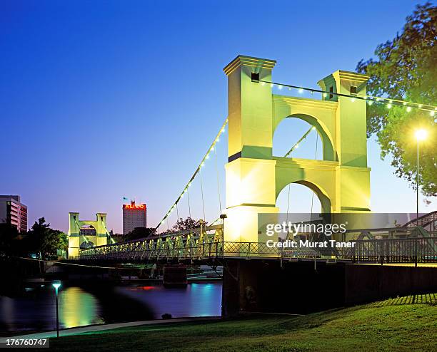 bridge over a river at night - waco stock-fotos und bilder