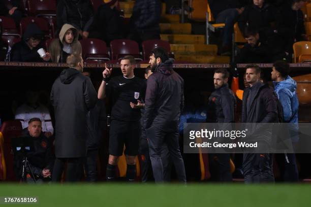 The referee stops play and speaks with Brian Barry-Murphy, Head Coach of Manchester City U21 during the EFL Trophy match between Bradford City and...