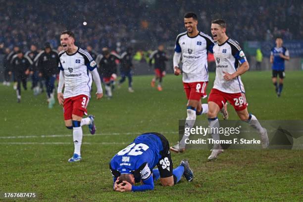 Marius Woerl of Bielefeld reacts after missing the final penalty while Moritz Heyer, Robert Glatzel and Miro Muheim of Hamburg celebrate during the...
