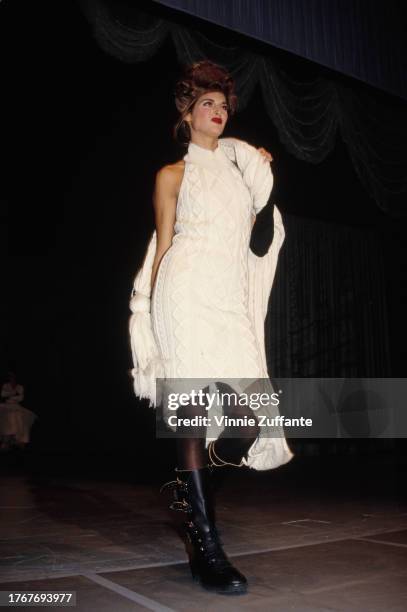 Model wearing a white midi dress, walks the catwalk at Jean Paul Gaultier's fashion show, in aid of the American Foundation for Aids Research , at...