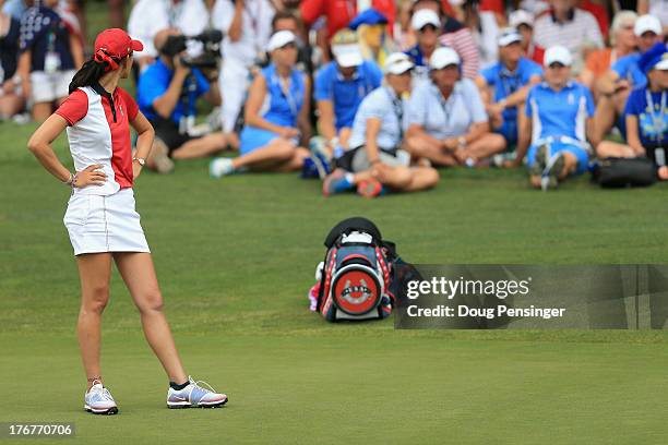 Michelle Wie of the United States Team looks on as Caroline Hedwall of Sweden and the European Team wint the 16th hole to bring their match to all...