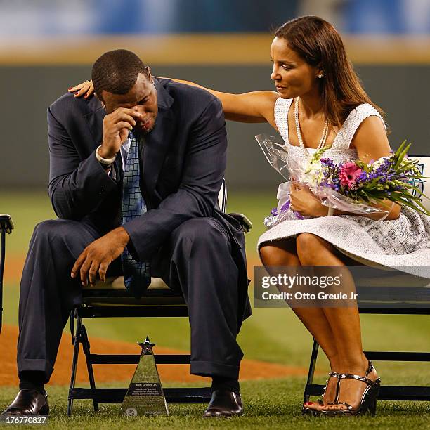 Former Mariners great, Ken Griffey Jr. Is comforted by his wife Melissa after he teared up following a video greeting from his son Trey during a...